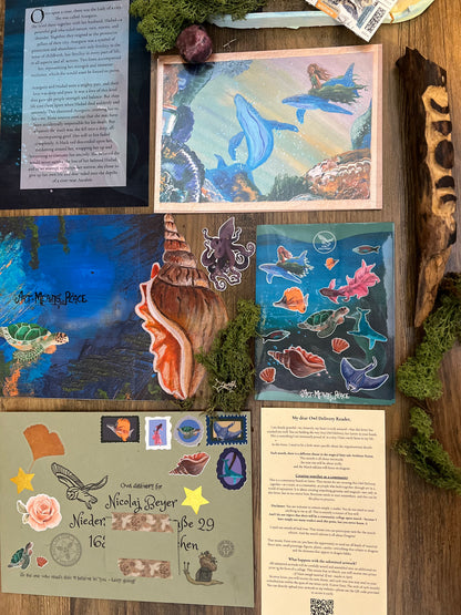 Collection of ocean-themed items including postcards, stickers, and a shell on a wooden surface.