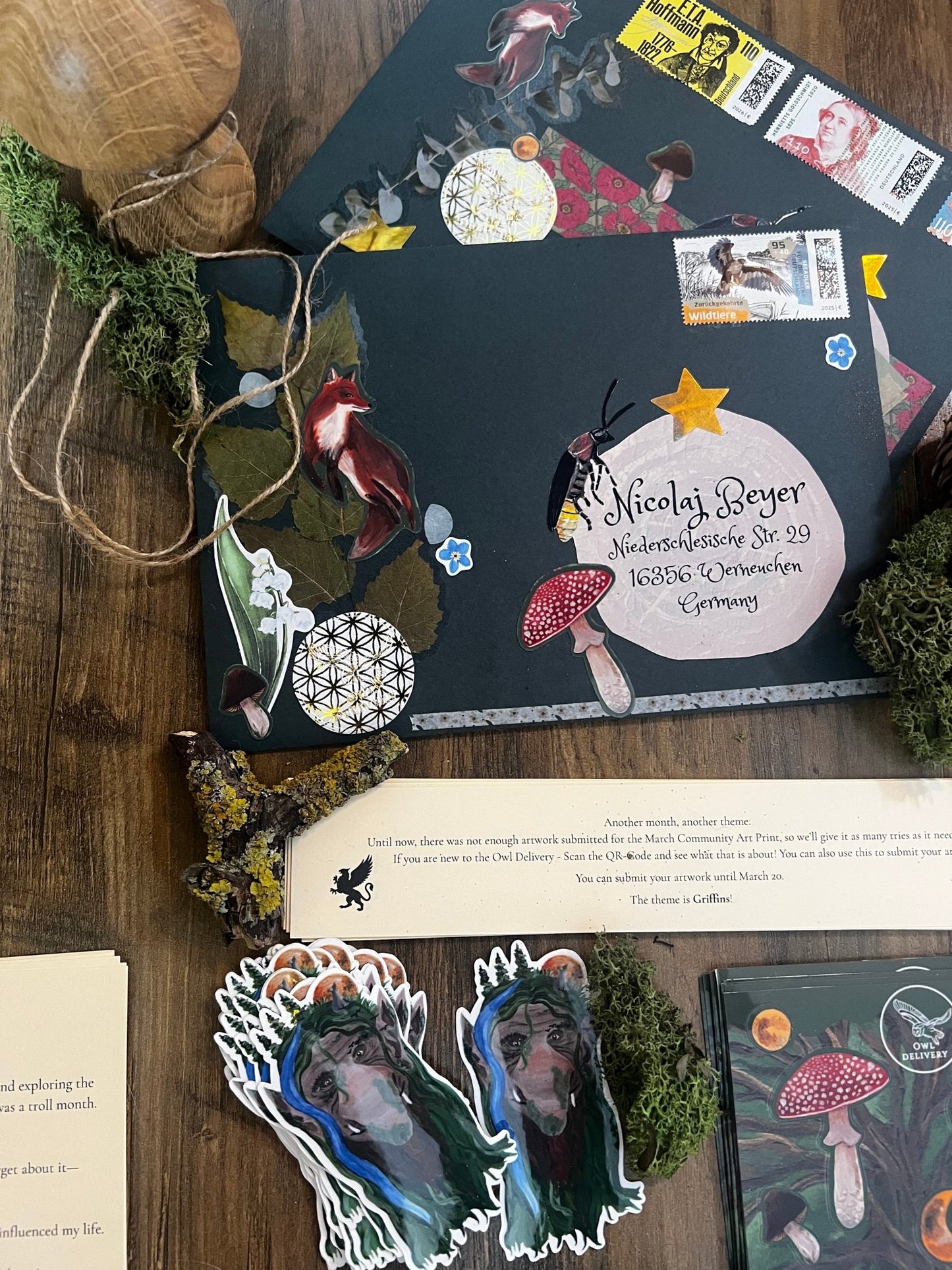 Decorative envelope with stickers and a letter on a wooden surface